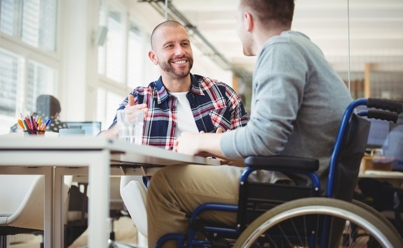 Man in a wheelchair at a desk